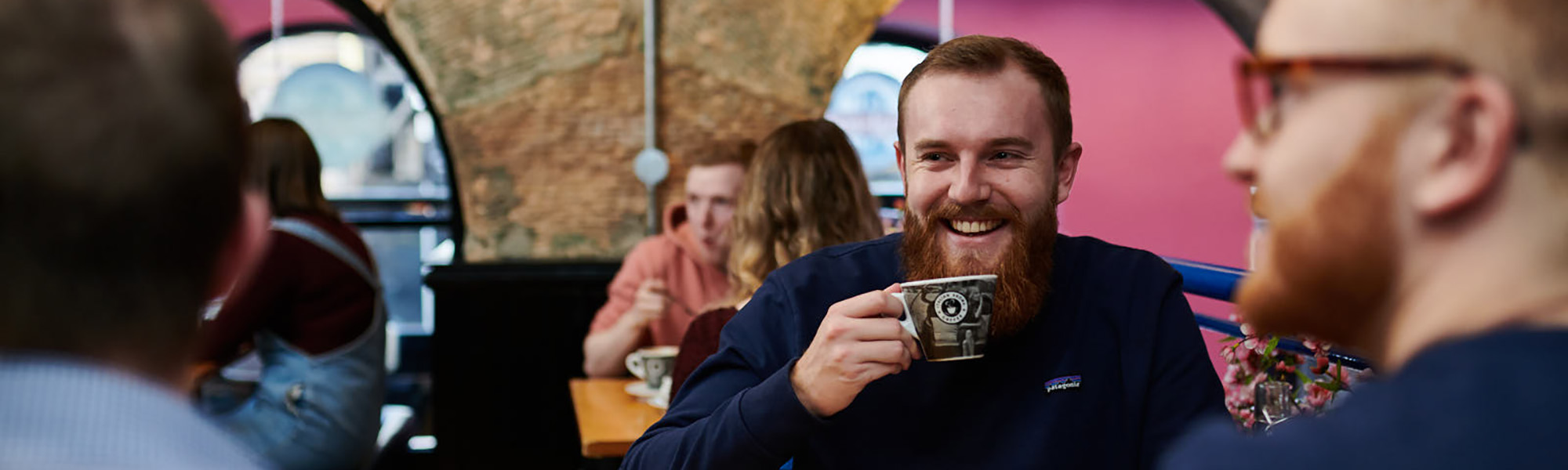 Man drinking a coffee with friends