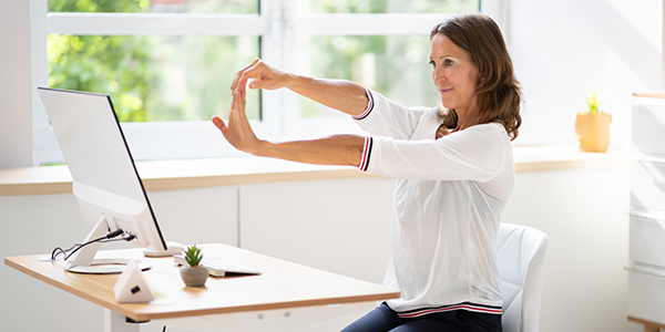 Woman stretching in her chair