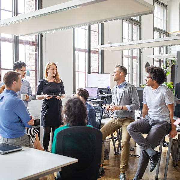 Group of colleagues having a stand up meeting 