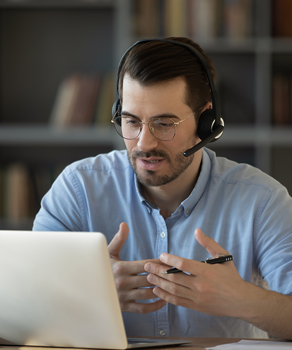 Man speaking to a colleague via video chat