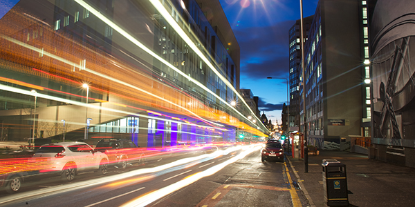 Night time shot of the Technology and Innovation Centre with traffic passing by