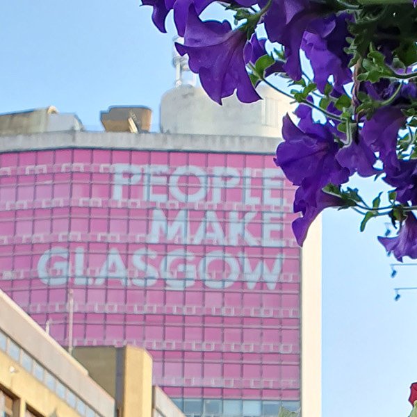 People make Glasgow sign on the Met Tower in Glasgow