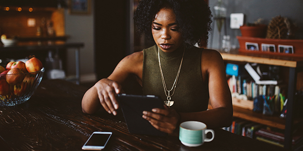 Woman reading a news article on a tablet