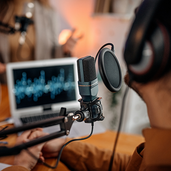 Man and women recording a conference 